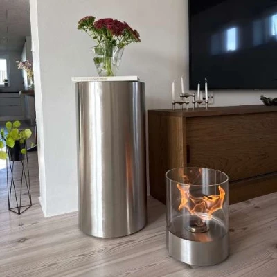 Dualis - Brushed Steel - Outdoor Bioethanol Fireplace | Buy here ScandiFlames Dualis bioethanol fireplace with a brushed steel fireplace body and a cylindrical safety glass