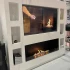 Foco One 1500 media wall built-in bio fireplace with black frame and safety glass.